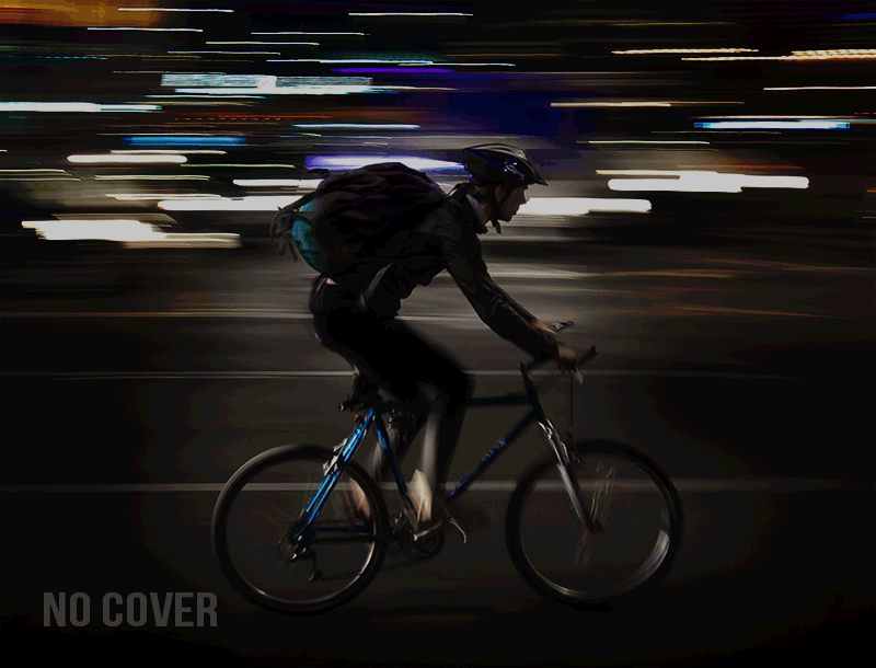 Cyclist riding at night, visible thanks to reflective spray